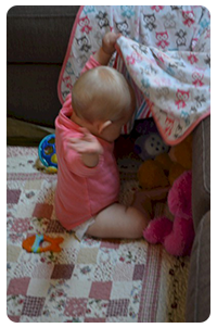 Sienna with toys under rug